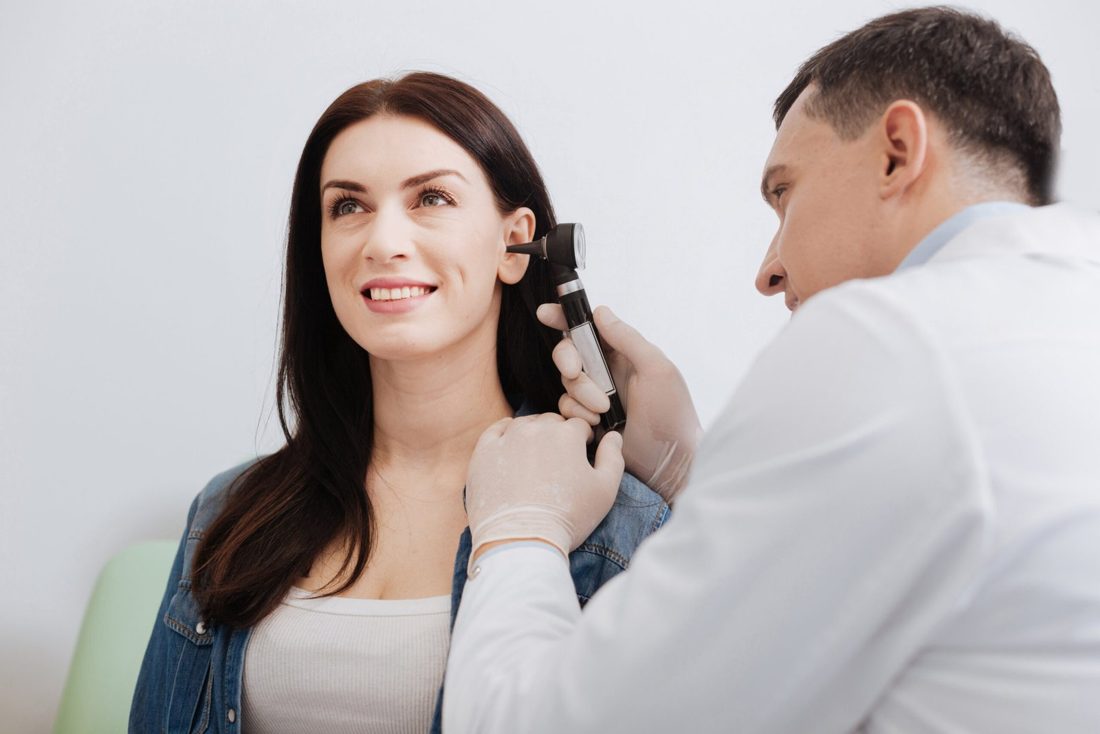 Clinician performing a gentle ear lavage to remove earwax at Elon Health Primary Care in Davenport, FL