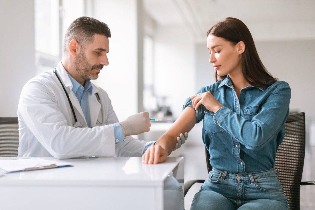 Family medicine provider preparing a vaccine for a patient during an immunization visit in Davenport, FL